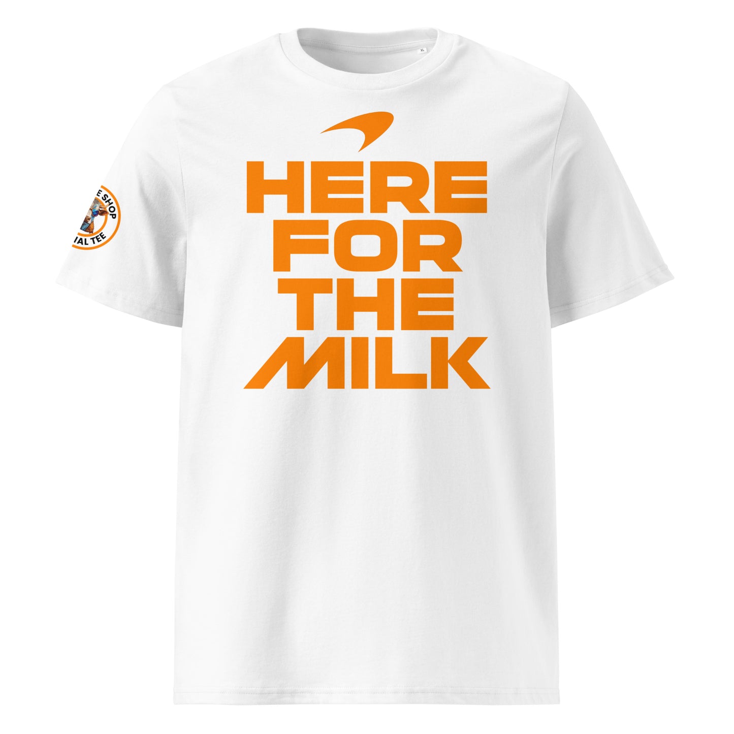 Front view of the white Indy 500 “Here for the Milk” T-Shirt featuring bold papaya orange text and a McLaren-inspired swoosh logo.