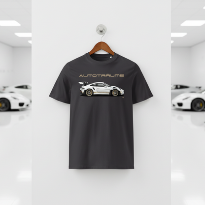 Anthracite unisex organic cotton AUTOTRÄUME GT3 RS T-shirt featuring a large, centred white Porsche-style GT3 RS car graphic with gold details hanging on a premium wooden hanger with a silver wall peg against a clean white wall panel in a bright modern sports car gallery with glossy floors and blurred white and silver sports cars on both sides.