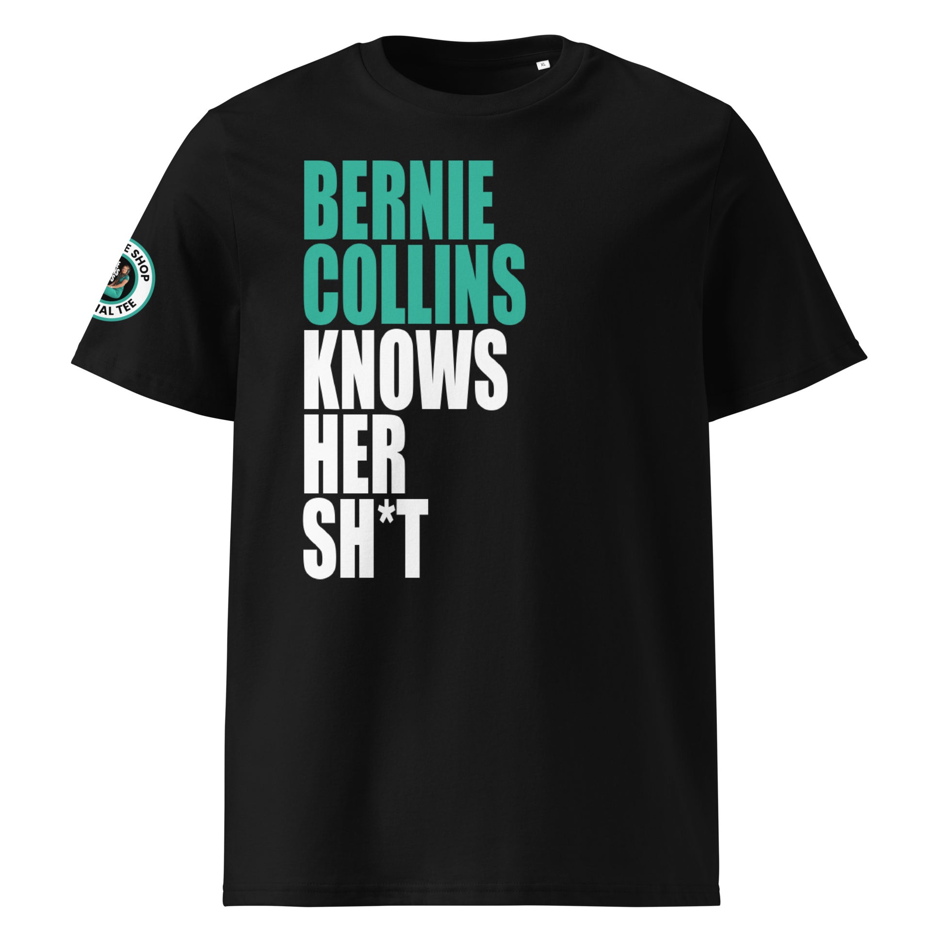Front view of black unisex t-shirt with bold slogan: “BERNIE COLLINS” in teal and “KNOWS HER SH*T” in white, stacked vertically. DTF print, perfect for Mercedes and F1 fans.