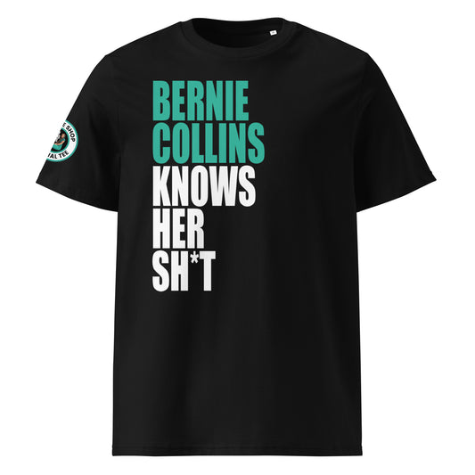 Front view of black unisex t-shirt with bold slogan: “BERNIE COLLINS” in teal and “KNOWS HER SH*T” in white, stacked vertically. DTF print, perfect for Mercedes and F1 fans.