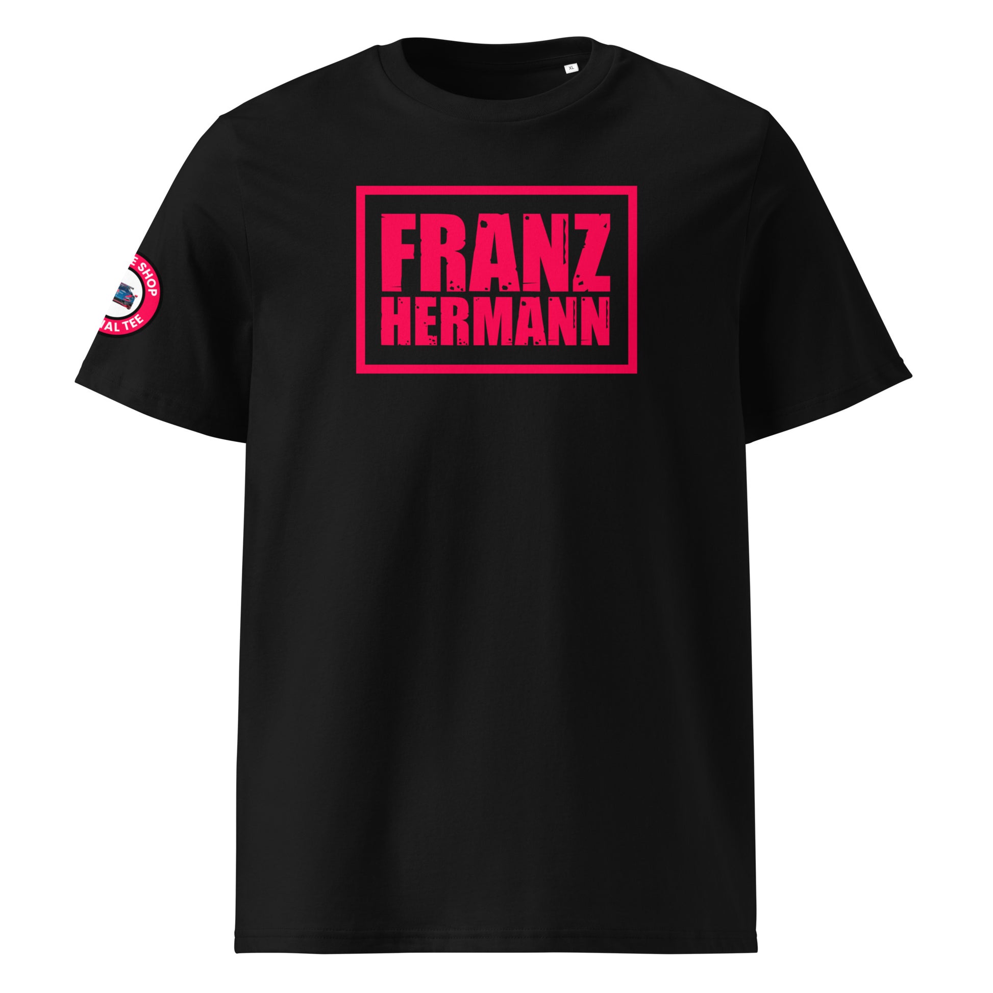 Front view of black unisex t-shirt with bold, distressed Red Bull Racing pink “Franz Hermann” box logo printed on the chest. DTF print, inspired by Verstappen’s Nürburgring GT3 moment. Modern F1 fan style.
