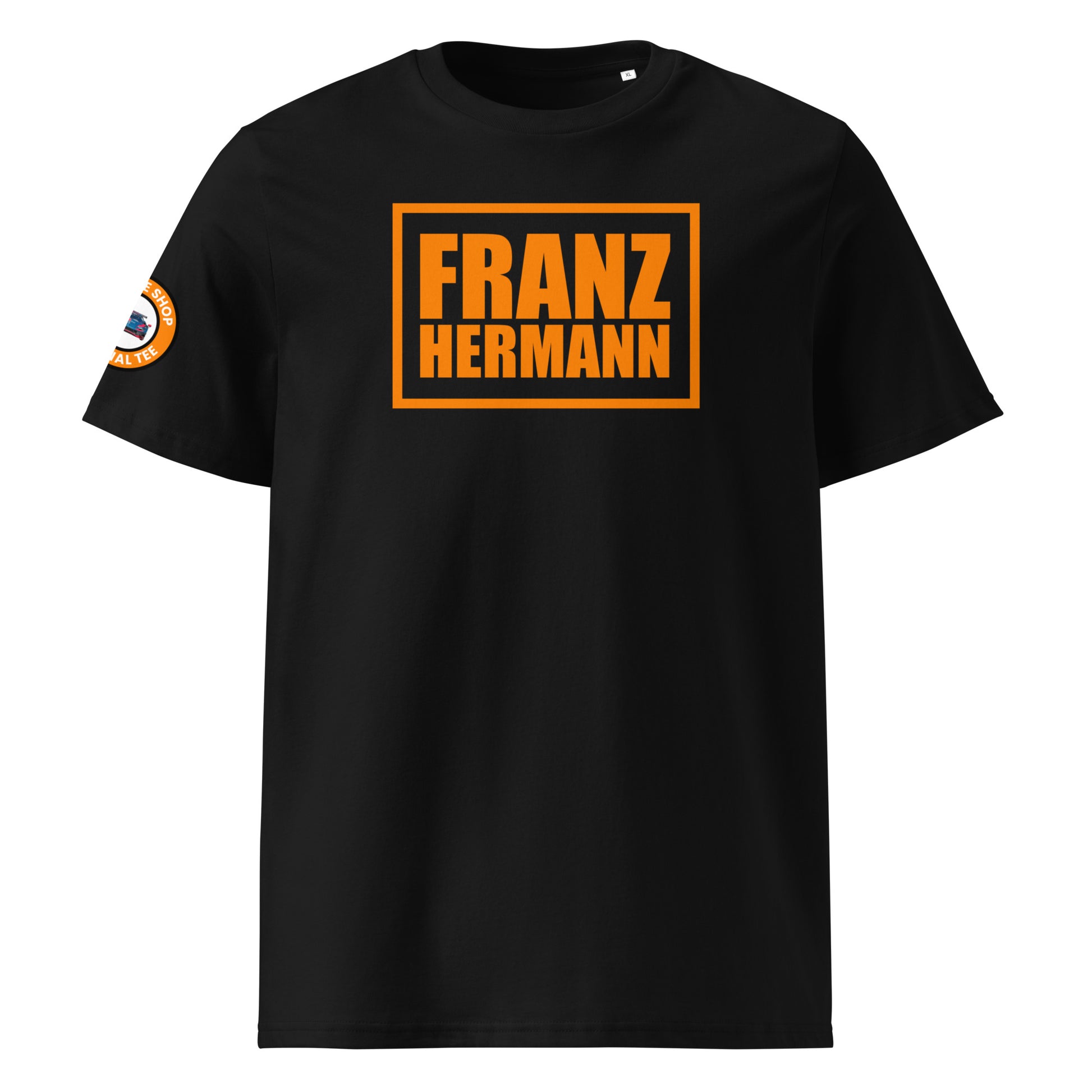 Front view of black unisex t-shirt with bold orange “Franz Hermann” box logo printed on the chest. DTF print, Dutch-inspired for Max Verstappen and F1 fans. Clean, professional motorsport style.