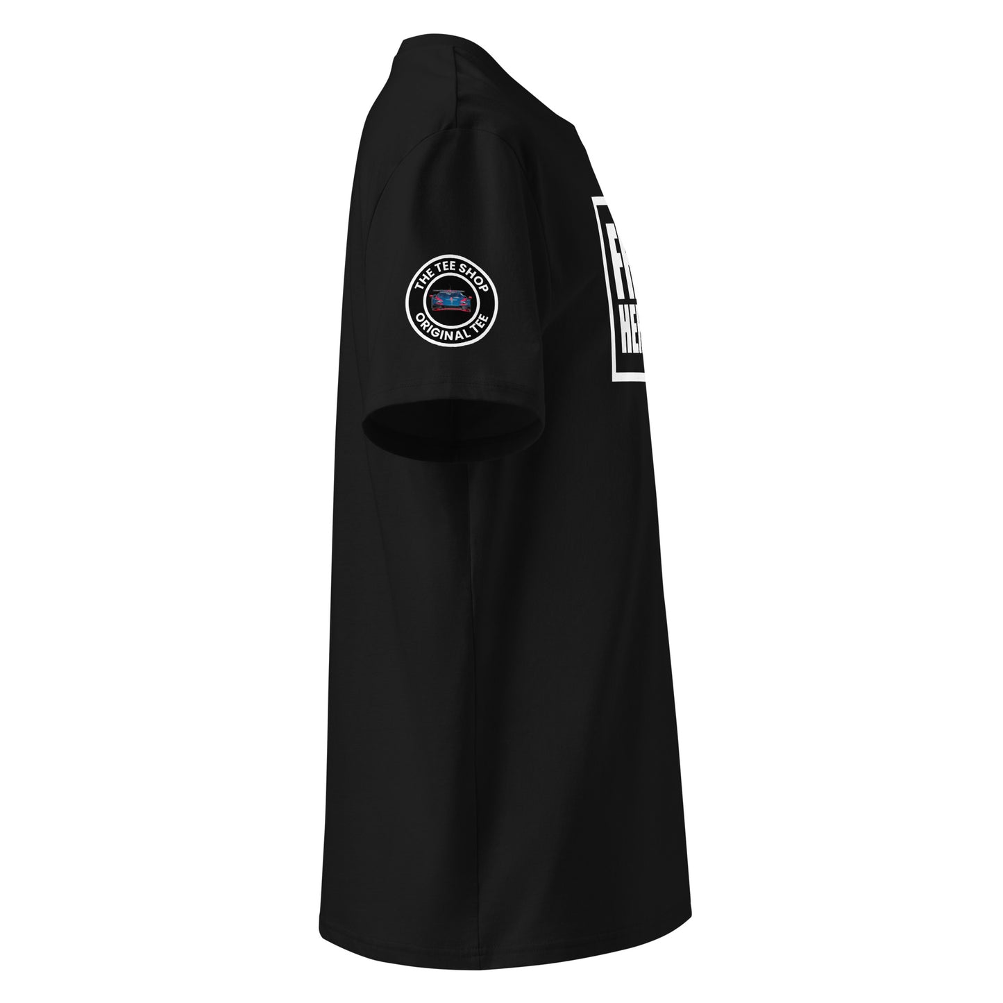 Right side view of black t-shirt showing The Tee Shop’s circular logo patch on the sleeve and the edge of the white Franz Hermann box logo. DTF printed, motorsport-inspired design for F1 fans.
