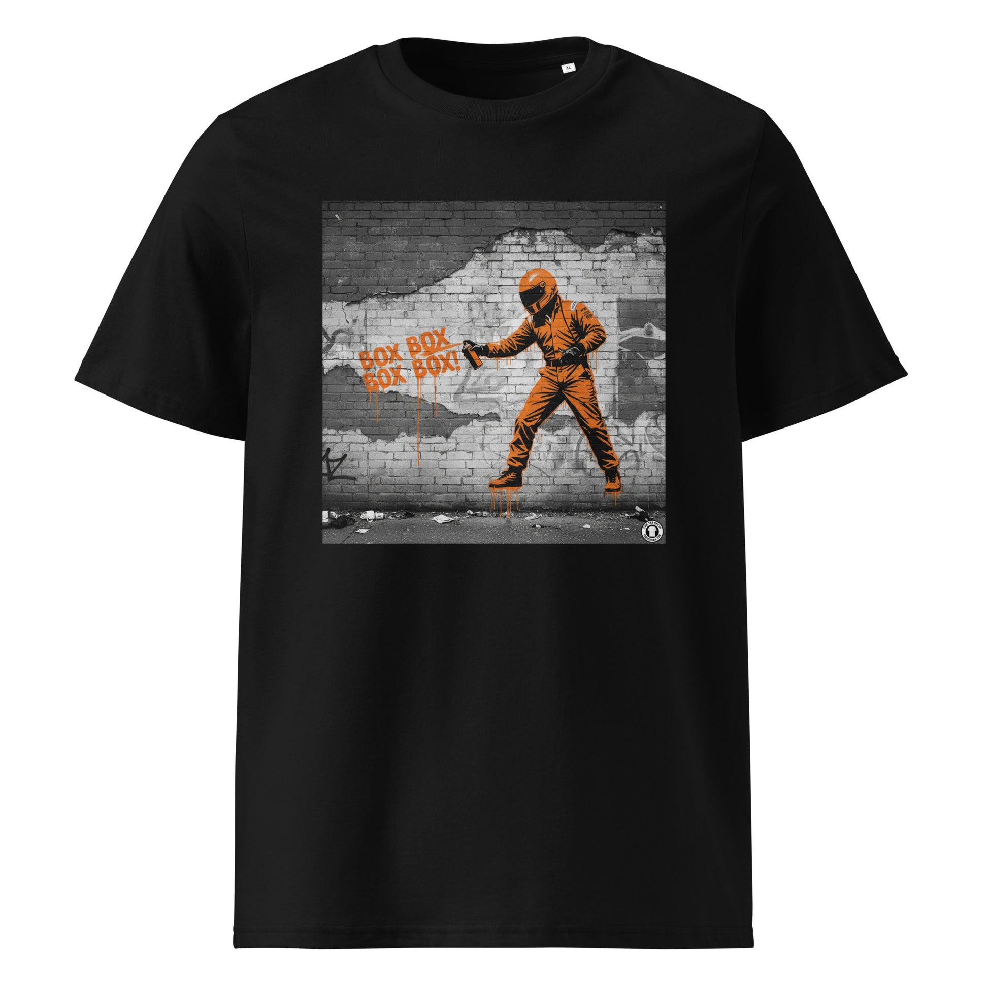 Black organic cotton F1 t-shirt with BOX BOX graffiti art of an F1 car on a brick wall, showcasing bold papaya orange and black design by TheTeeShop.