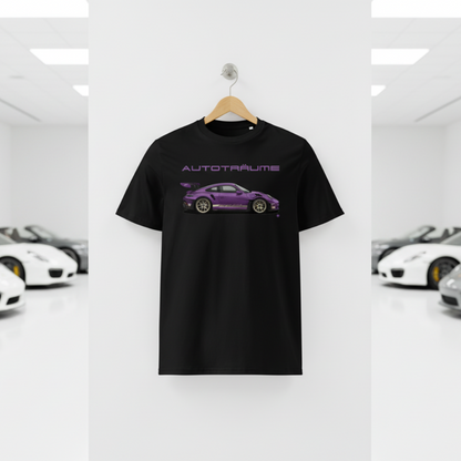 Black AUTOTRÄUME GT3 T‑shirt with a purple Porsche‑style car illustration hanging on a premium wooden hanger and silver wall peg against a central white wall in a bright sports car gallery, with a glossy white floor and blurred white and silver sports cars running down both sides.
