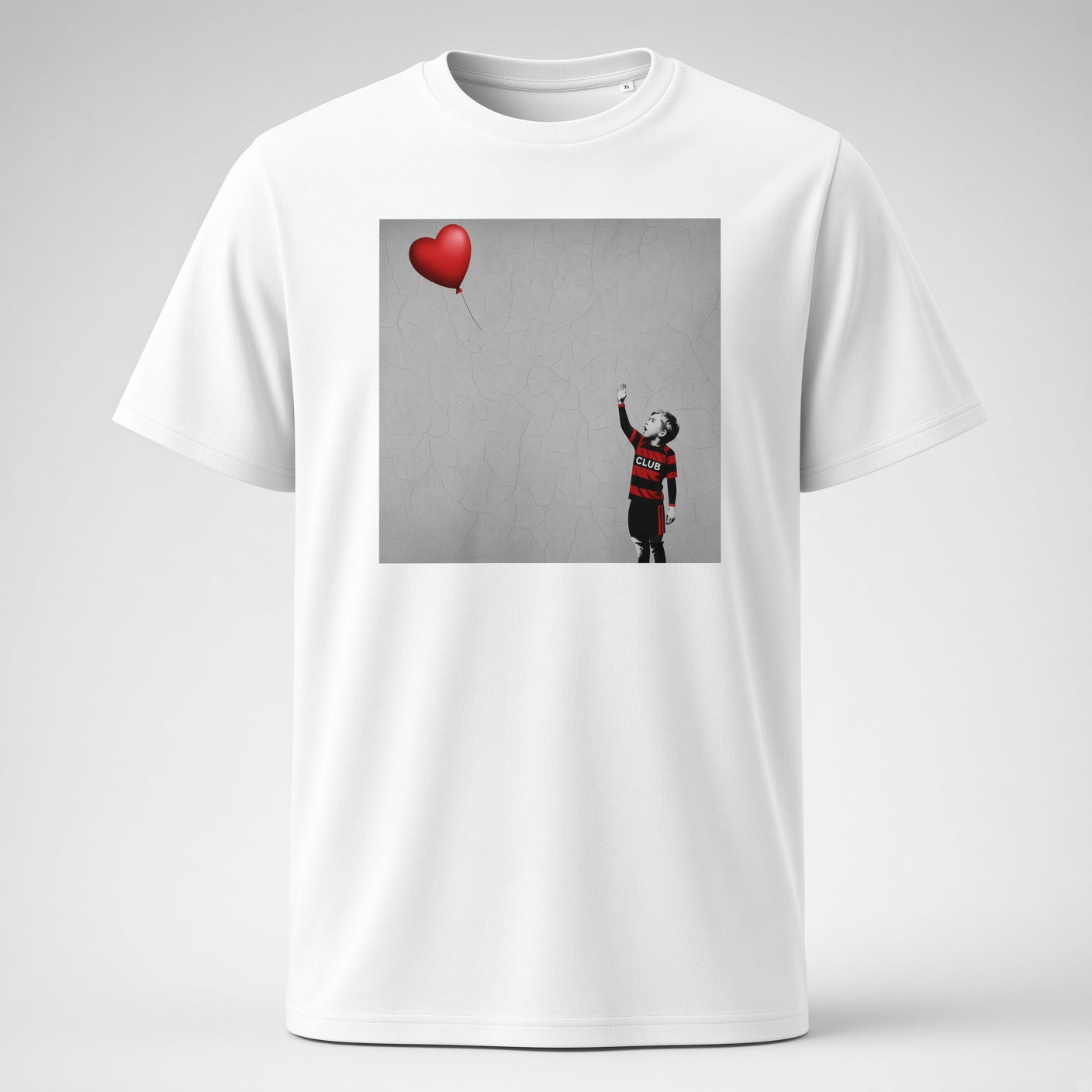 White Blackheath Boy Dreams street art t-shirt featuring a stencil-style boy in Blackheath rugby club colours reaching for a red heart balloon on a grey wall background