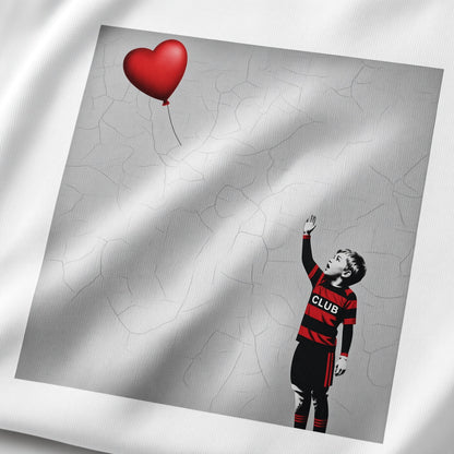 Close-up of the Blackheath Boy Dreams street art t-shirt print showing a stencil-style boy in Blackheath rugby club colours reaching for a red heart balloon on a textured grey wall background