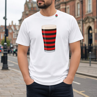 Close-up of a white Blackheath rugby Mega Pint t-shirt showing the red and black striped pint glass graphic, photographed on a London street for Blackheath match days and England supporters