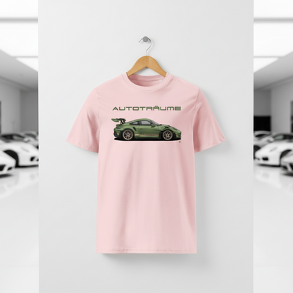 Cotton pink AUTOTRÄUME GT3 T‑shirt with an olive green Porsche‑style car illustration hanging on a premium wooden hanger and silver peg against a central white wall in a bright sports car gallery, with a glossy white floor and blurred white and silver sports cars running down both sides.