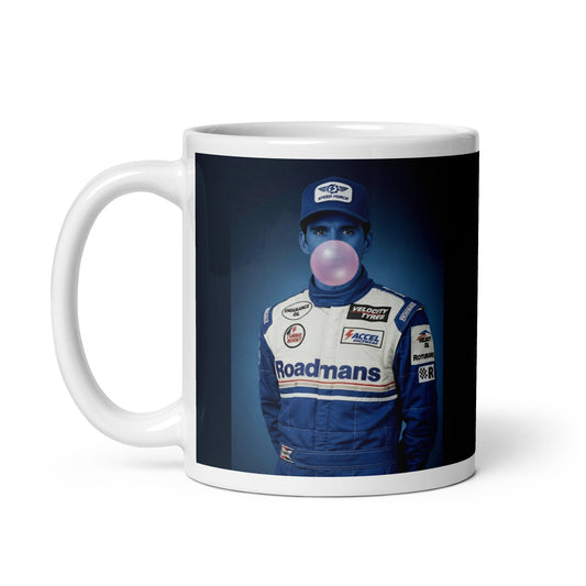 White ceramic 11oz mug featuring a pop-art style portrait of Damon Hill in a blue racing suit and cap, blue-tinted face, and blowing a bubblegum bubble, set against a blue background.