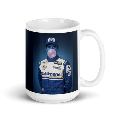 White ceramic 15oz mug featuring a pop-art style portrait of Damon Hill in a blue racing suit and cap, blue-tinted face, and blowing a bubblegum bubble, set against a blue background.