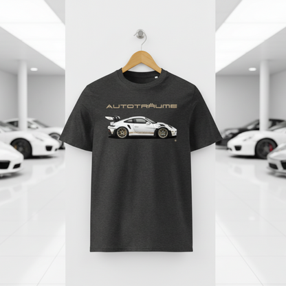 Dark heather grey unisex organic cotton AUTOTRÄUME GT3 RS T-shirt featuring a large, centred white Porsche-style GT3 RS car graphic with gold details hanging on a premium wooden hanger with a silver wall peg against a clean white wall panel in a bright modern sports car gallery with glossy floors and blurred white and silver sports cars on both sides.