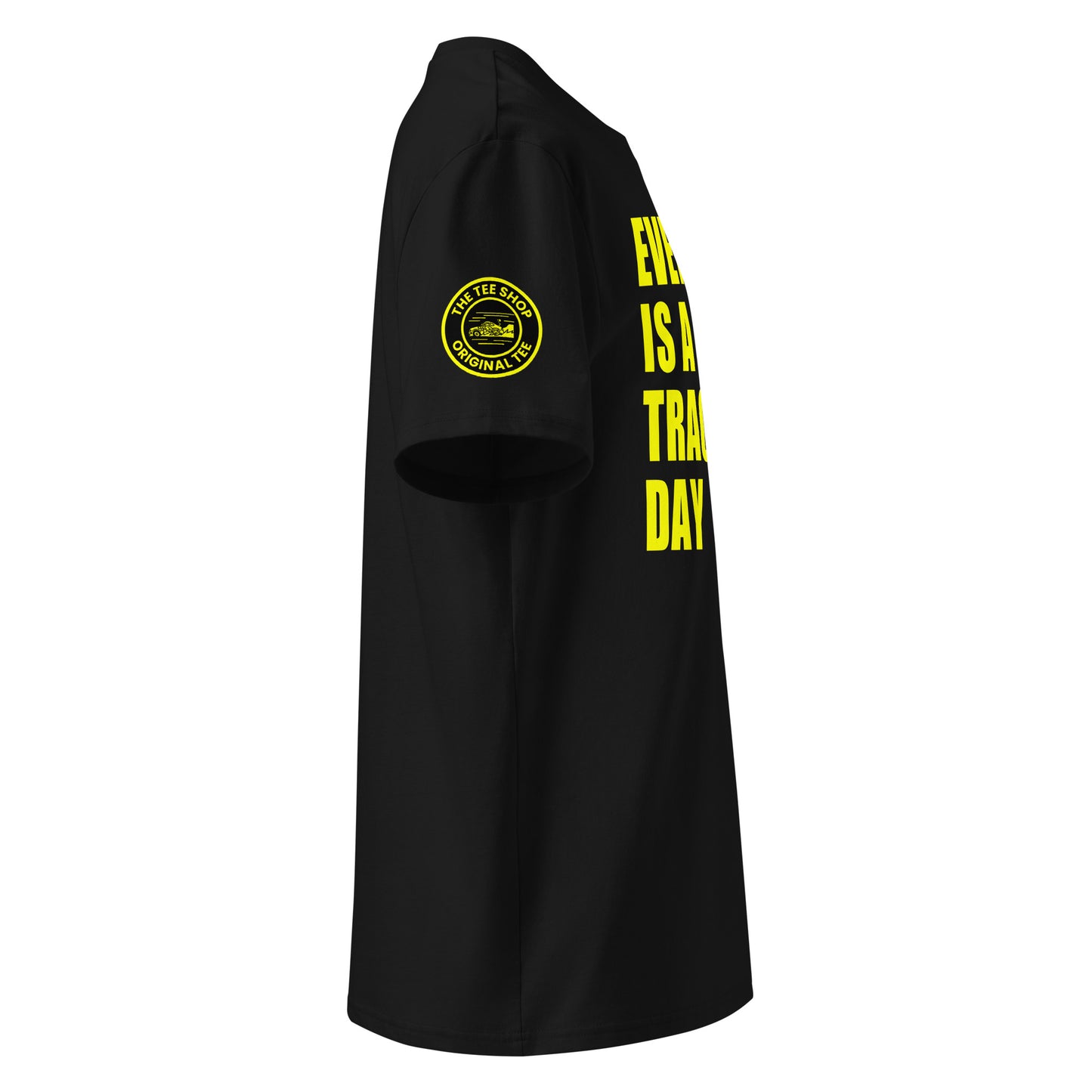 Right side view of black t-shirt showing The Tee Shop’s unique race car logo on the sleeve and edge of the yellow “EVERY DAY IS A TRACK DAY” front print. DTF print, motorsport-inspired style.
