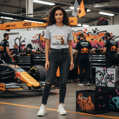 Female model wearing the heather grey organic cotton PAPAYA Fans Like No Other Graffiti Art F1 T-Shirt with #FANSLIKENOOTHER design, standing confidently and stylishly with arms relaxed by her sides in a motorsport paddock environment, tee clean and design fully visible.