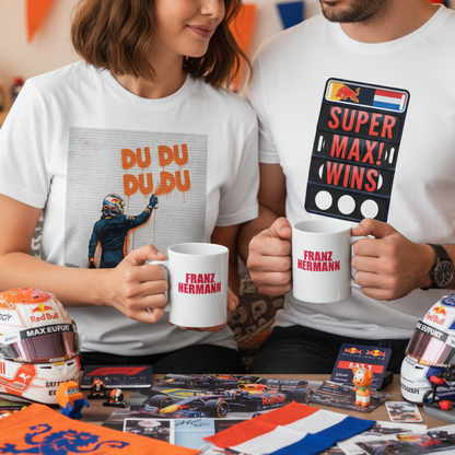 Couple wearing Max Series DU DU DU DU and SUPER MAX WINS t-shirts, both holding the Franz Hermann Mug in a cosy, F1-inspired living room.