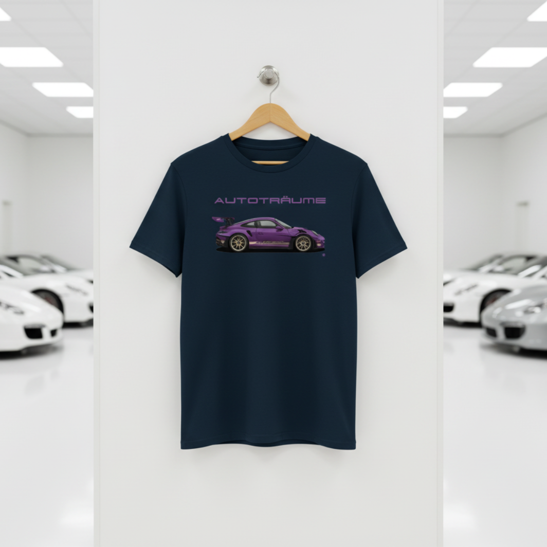 French navy AUTOTRÄUME GT3 T‑shirt with a purple Porsche‑style car illustration hanging on a premium wooden hanger and silver wall peg against a central white wall in a bright sports car gallery, with a glossy white floor and blurred white and silver sports cars running down both sides.