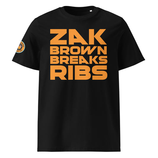 Front View: The front of the t-shirt features the bold "Zak Brown Breaks Ribs" print in papaya writing on a black background, capturing the humour and excitement of Zak Brown's famous celebrations.