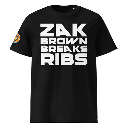 The front of thIis McLaren t-shirt features the "Zak Brown Breaks Ribs" print in white writing on a black background, capturing the humour and excitement of Zak Brown's famous celebrations.