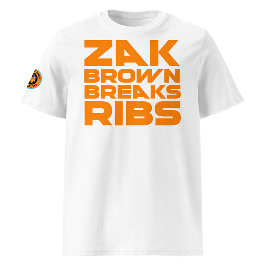 Front View: The front of the t-shirt features the bold "Zak Brown Breaks Ribs" print in papaya writing on a white background, capturing the humour and excitement of Zak Brown's famous celebrations.