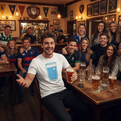 Man wearing white Garryowen Mega Pint Rugby T-Shirt laughing with a large group of friends and supporters in a lively rugby clubhouse bar.