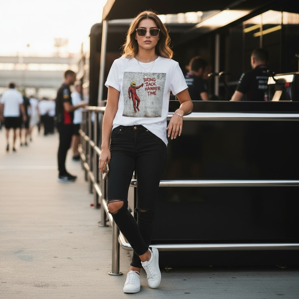 Woman wearing the Hammer Time t-shirt and ripped jeans leaning against a railing.