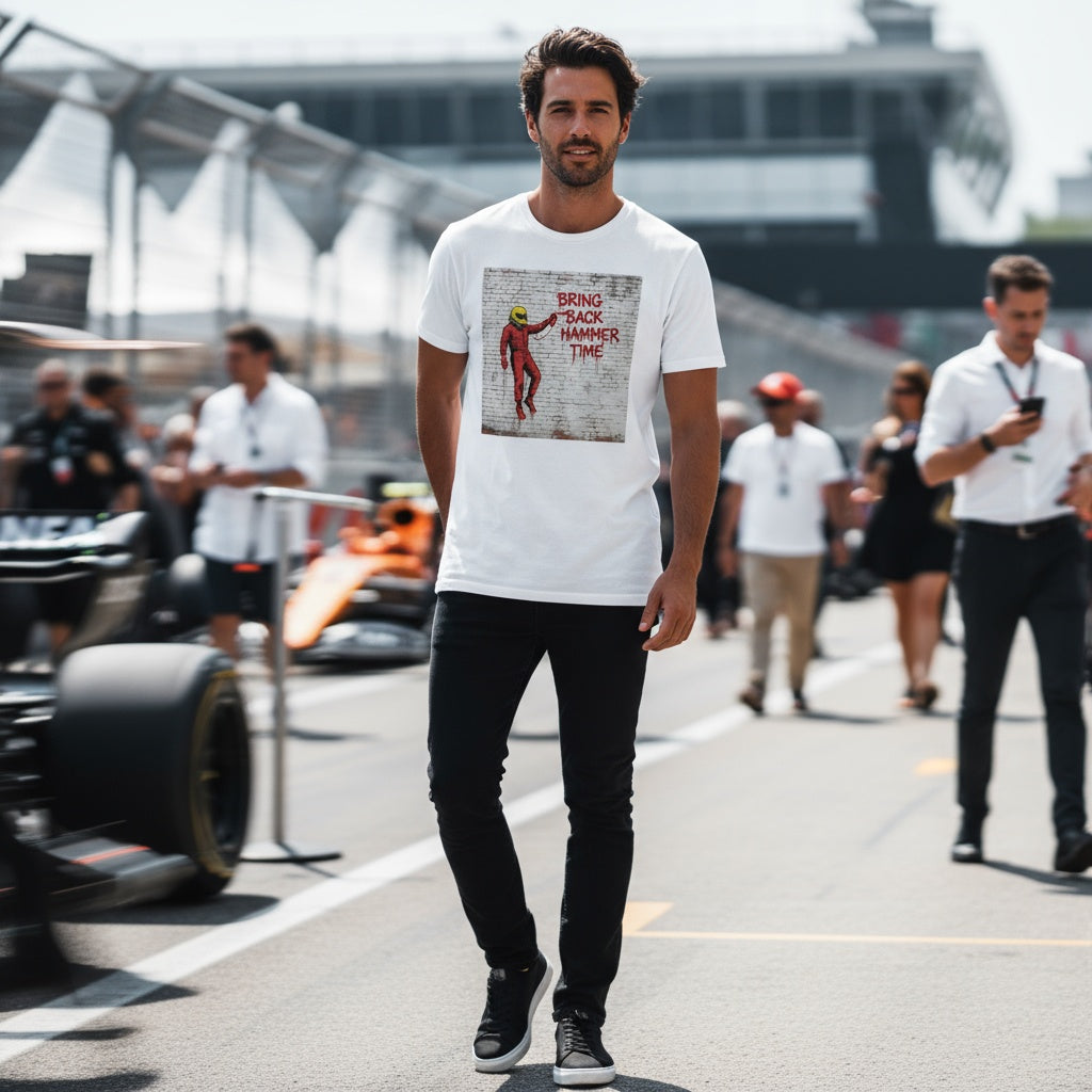 Man walking on a race track wearing a white t-shirt with a graphic design.