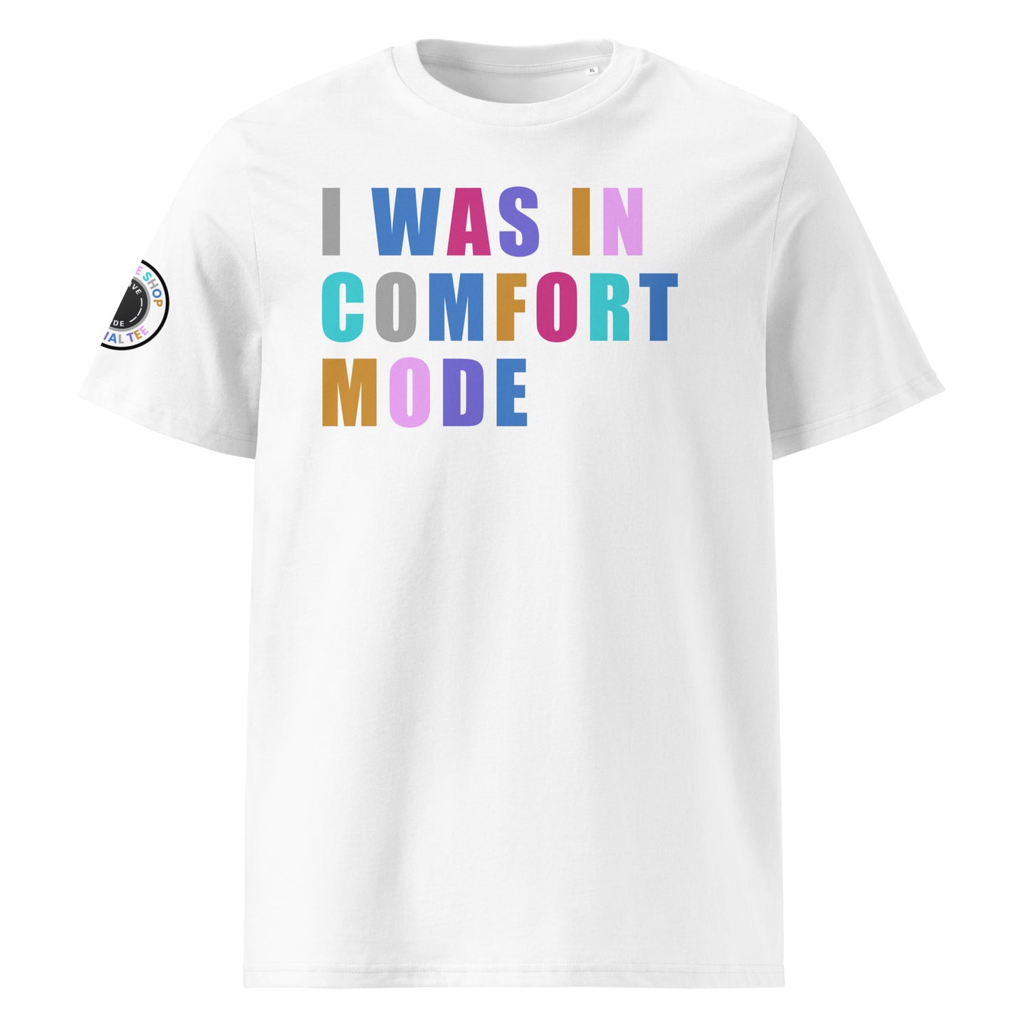 Front view of white unisex t-shirt with “I WAS IN COMFORT MODE” slogan in multi-colour harlequin print across the chest. DTF print, playful car meet and petrolhead style.