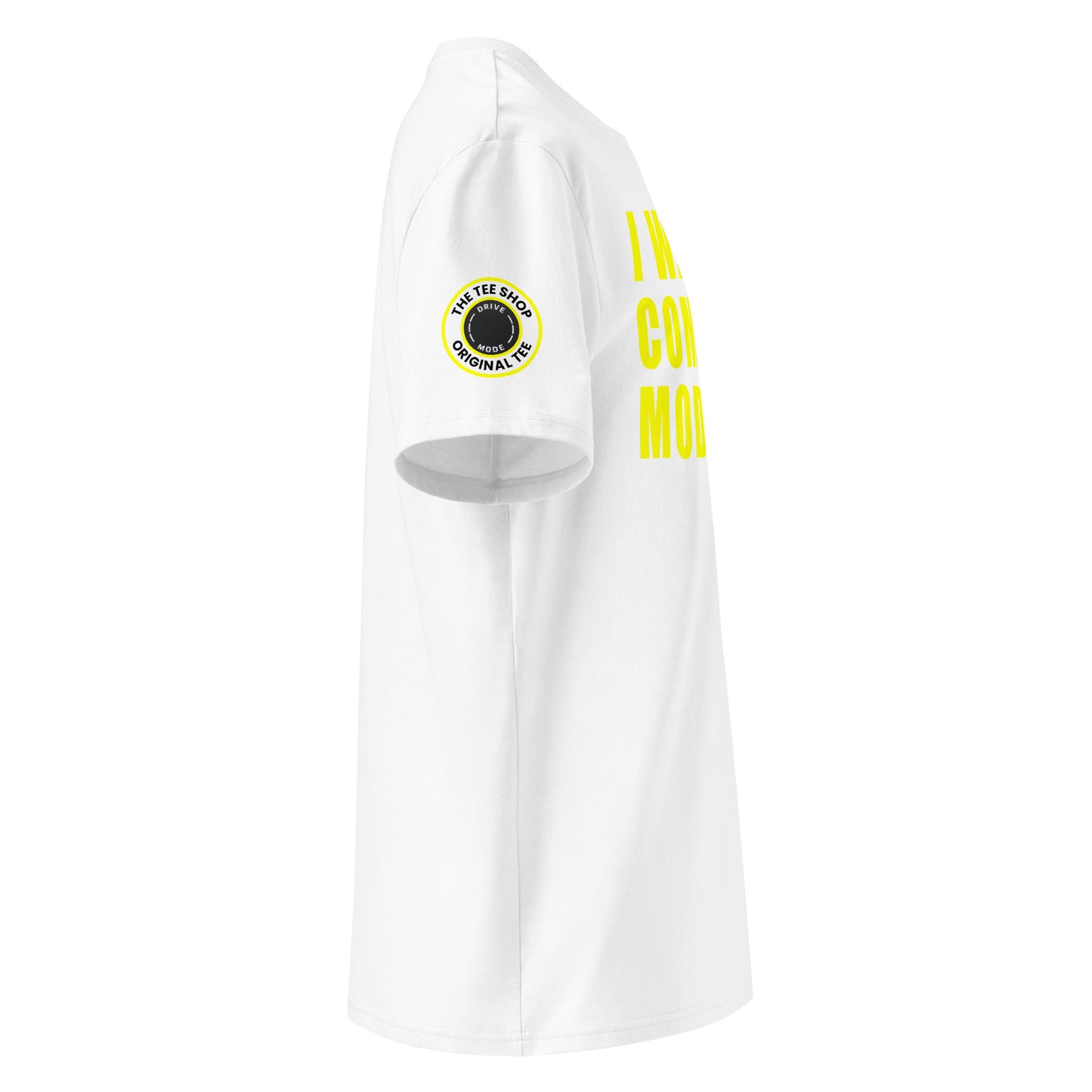 Right side view of white t-shirt showing The Tee Shop’s drive mode button logo patch on the sleeve and edge of the yellow “I WAS IN COMFORT MODE” chest print. DTF print, car culture style.