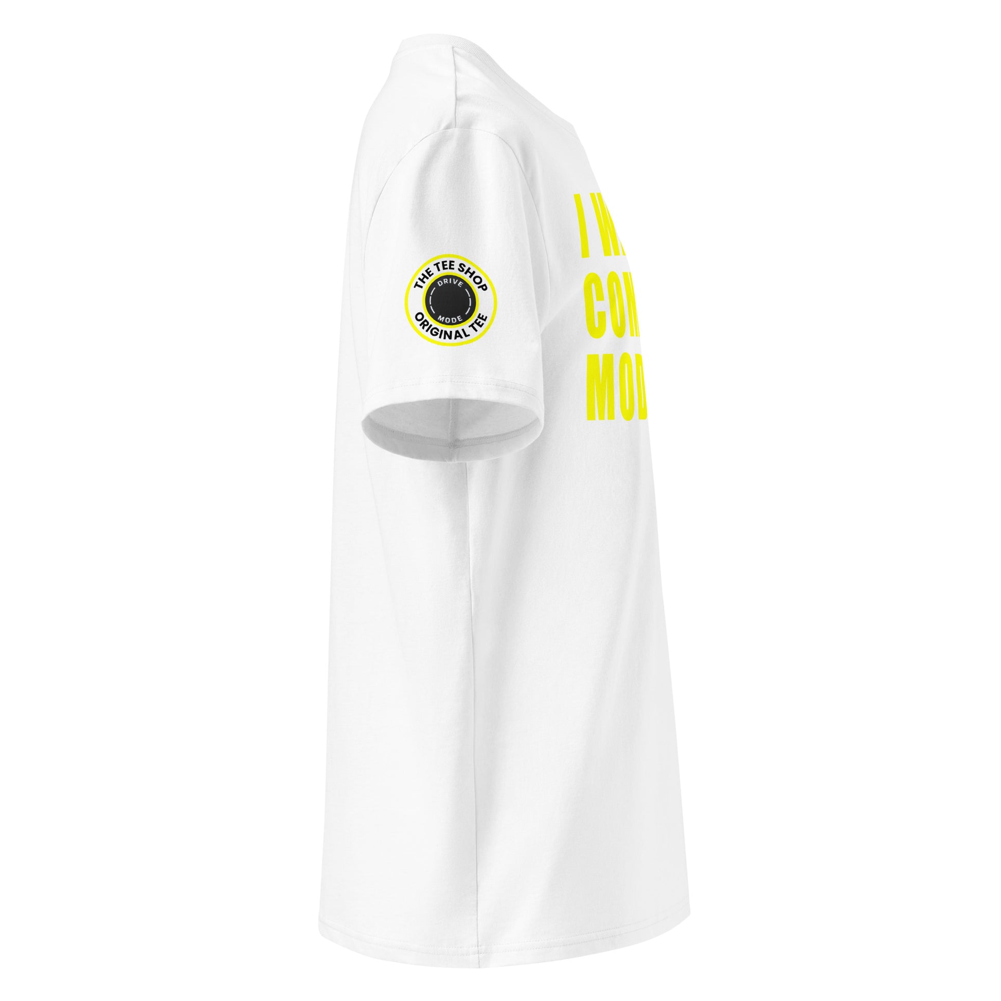 Right side view of white t-shirt showing The Tee Shop’s drive mode button logo patch on the sleeve and edge of the yellow “I WAS IN COMFORT MODE” chest print. DTF print, car culture style.