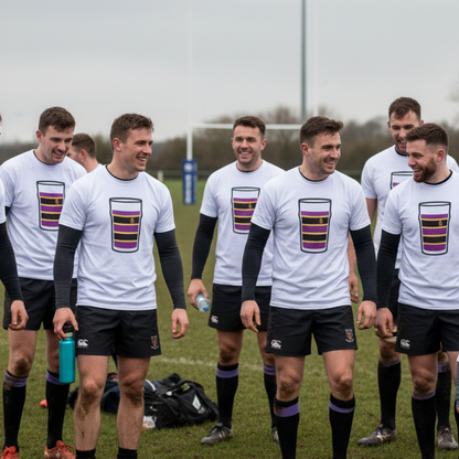 Group of rugby players wearing white Instonians Mega Pint Rugby T-Shirts walking together on the pitch after a match.