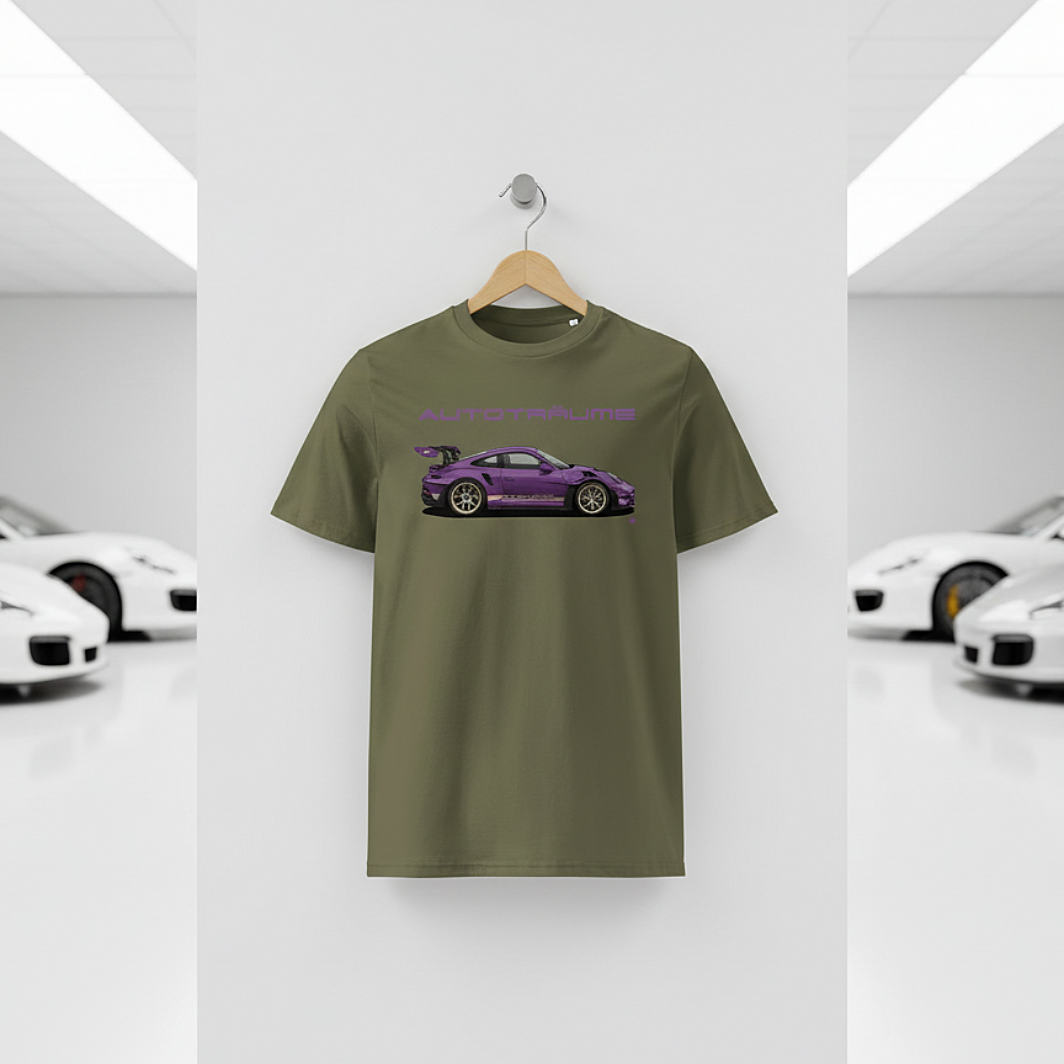 Khaki AUTOTRÄUME GT3 T‑shirt with a purple Porsche‑style car illustration hanging on a premium wooden hanger and silver wall peg against a central white wall in a bright sports car gallery, with a glossy white floor and blurred white and silver sports cars running down both sides.