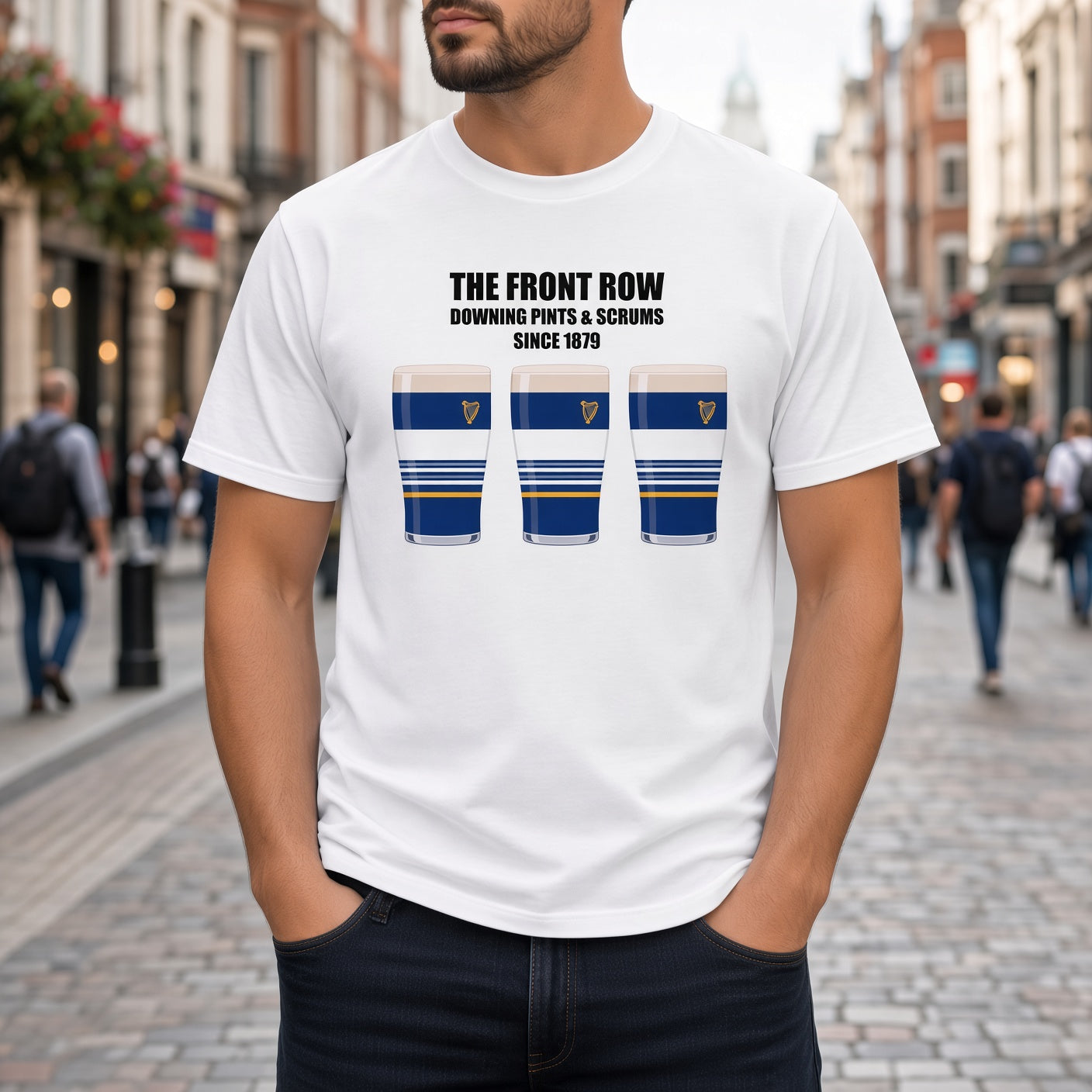 Close-up of a white Leinster rugby t-shirt reading “The Front Row - Downing Pints & Scrums Since 1879” with three blue striped pint graphics featuring a harp crest for Leinster match day supporters