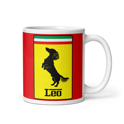 White ceramic 11oz mug with a bold red background featuring a yellow shield, the Italian tricolor, and a black silhouette of a dachshund, with the text “Leo”—inspired by quick dogs.