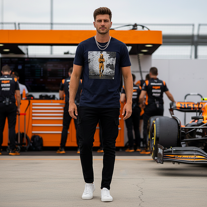 Male model wearing the French Navy organic cotton Papaya Driver Mood Graffiti Art F1 T-Shirt featuring a McLaren-inspired driver in vibrant papaya orange graffiti, standing with arms relaxed by his sides in a Papaya F1 paddock environment.