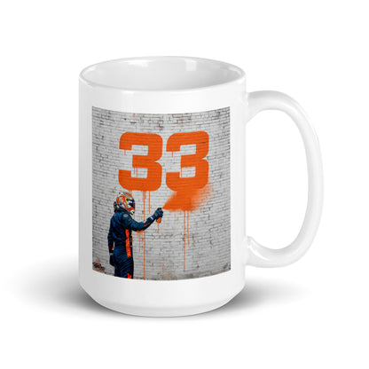White ceramic 15oz mug featuring a street art illustration of a racing driver spray-painting a bold orange number 33 on a brick wall, inspired by Max Verstappen.