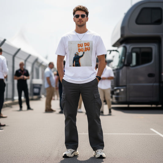 Man wearing TheTeeShop’s Max Series DU DU DU DU Graffiti T-Shirt featuring Max Verstappen spray-painting his famous chant, standing in a Formula 1 paddock surrounded by fans, perfect for Max Verstappen supporters and F1 enthusiasts.
