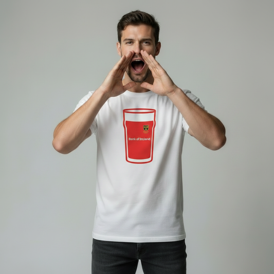 Male model shouting with hands cupped around mouth wearing white rugby t-shirt with red Munster pint glass graphic and Bank of Ireland text on light grey studio background
