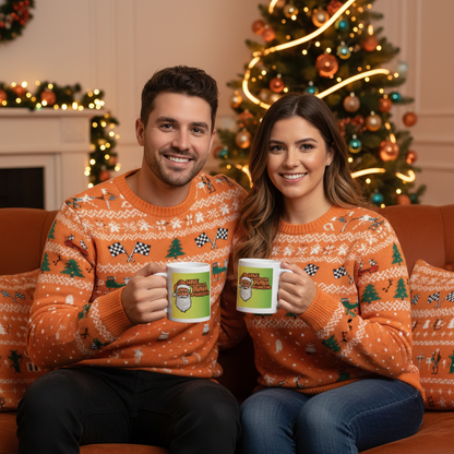 F1 fan couple in matching papaya or McLaren-style Christmas jumpers, each holding a Neon Papaya McChristmas Mug in a festive living room with a Christmas tree and neon papaya accents.