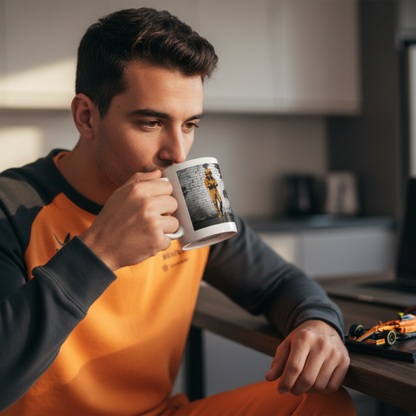 Male F1 fan in papaya loungewear, drinking from the PAPAYA Driver Mood Mug at home, with McLaren memorabilia in the background.