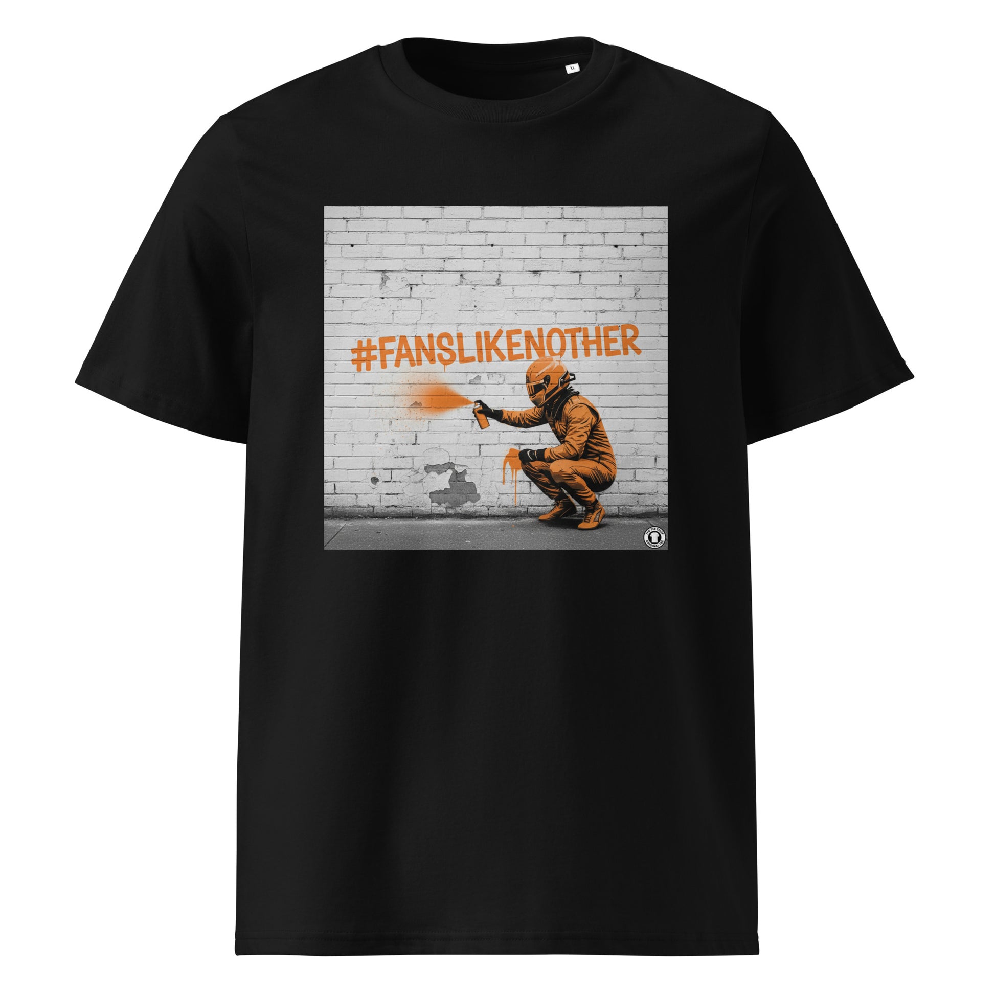 Black organic cotton F1 t-shirt with Papaya Fans Like No Other graffiti art design, featuring an F1 driver spray painting #FANSLIKENOOTHER in papaya orange on a brick wall. Perfect for McLaren fans and the Papaya Army.
