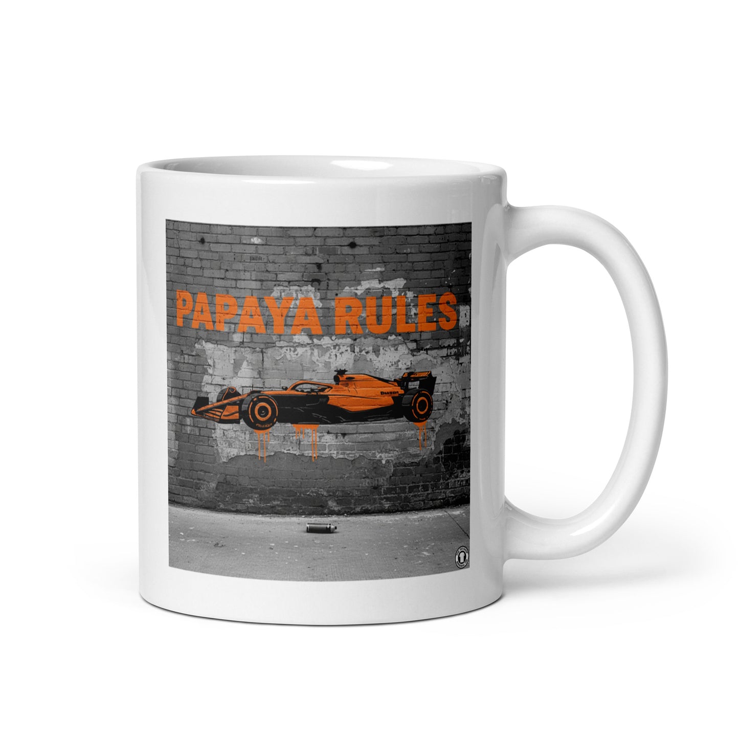 White ceramic 11oz mug featuring a street art illustration of a papaya orange McLaren F1 car and “PAPAYA RULES” graffiti on a distressed brick wall.
