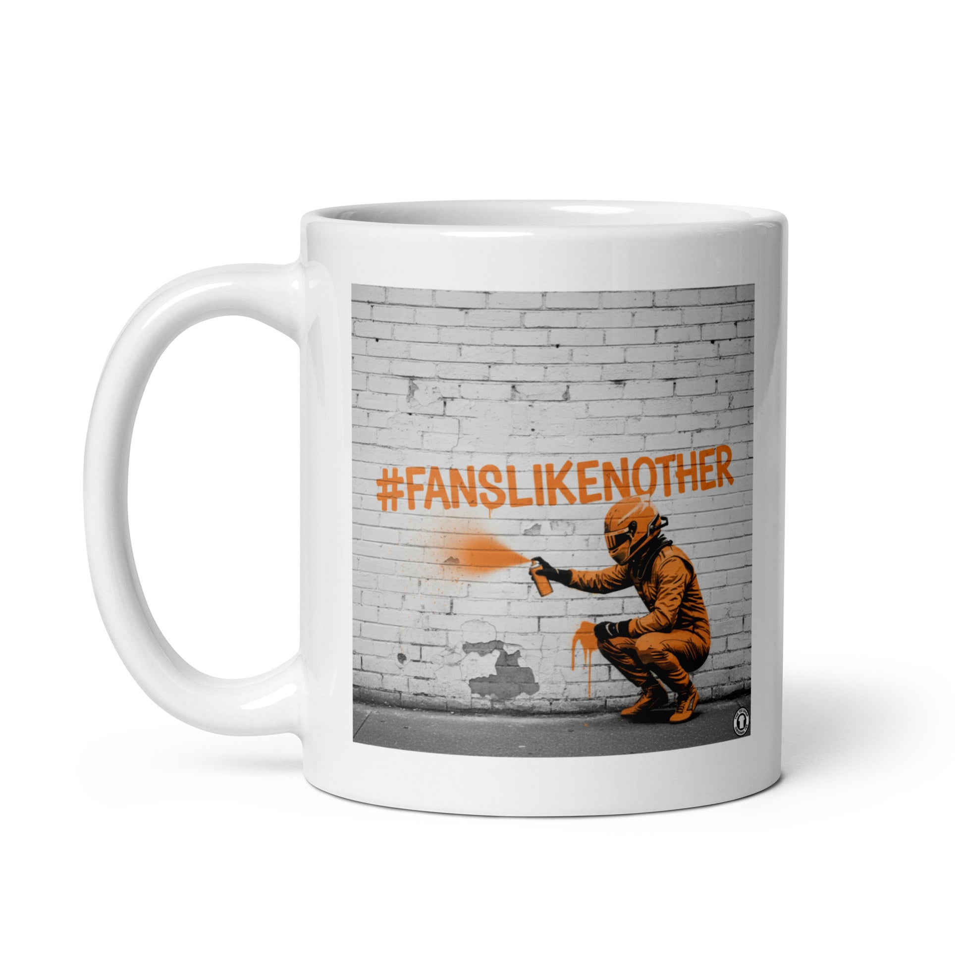 White ceramic 11oz mug featuring a street art illustration of a racing driver spray-painting the hashtag #FANSLIKENOOTHER in papaya orange on a brick wall, inspired by McLaren F1 fans.
