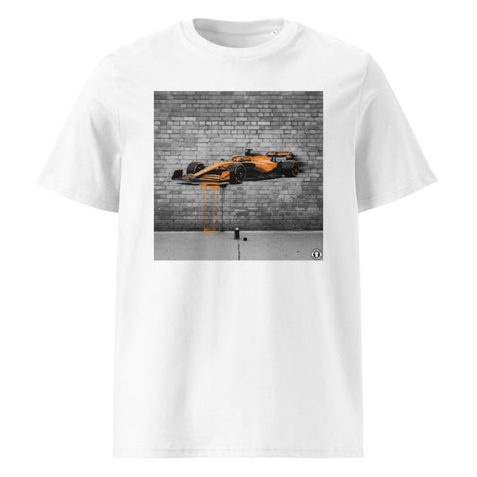 White unisex t-shirt featuring a graffiti-style mural of a McLaren F1 car in papaya orange with paint drips, part of TheTeeShop’s Papaya Series in the Paddock Collection.