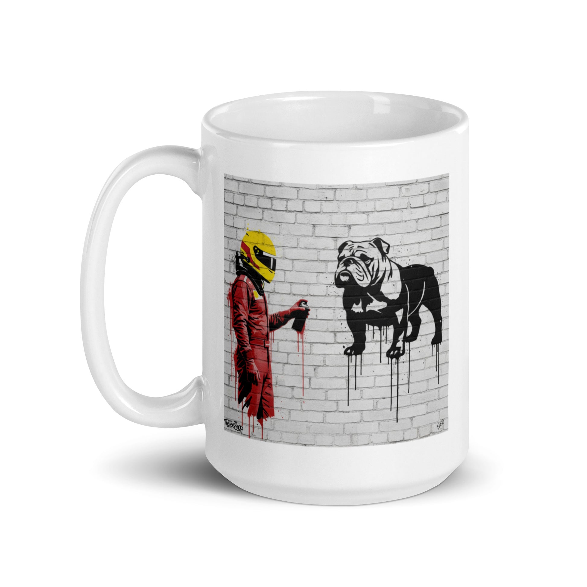 White ceramic 15oz mug featuring an art illustration of a racing driver in red overalls and a yellow helmet spray-painting a black and white bulldog on a white brick wall, inspired by a man and a dog.