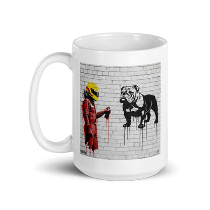 White ceramic 15oz mug featuring an art illustration of a racing driver in red overalls and a yellow helmet spray-painting a black and white bulldog on a white brick wall, inspired by a man and a dog.