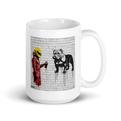 White ceramic 15oz mug featuring a street art illustration of a racing driver in red overalls and a yellow helmet spray-painting a black and white bulldog on a white brick wall, inspired by a man and his dog.