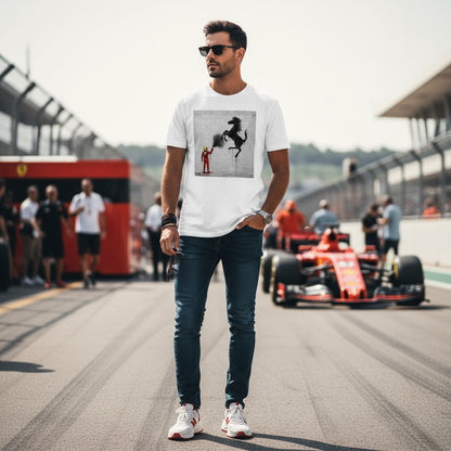 Man wearing TheTeeShop’s Pitwall Series Stallion Graffiti T-Shirt, walking on the grid with a racing car and team members in the background, showcasing stylish, inspired motorsport streetwear.