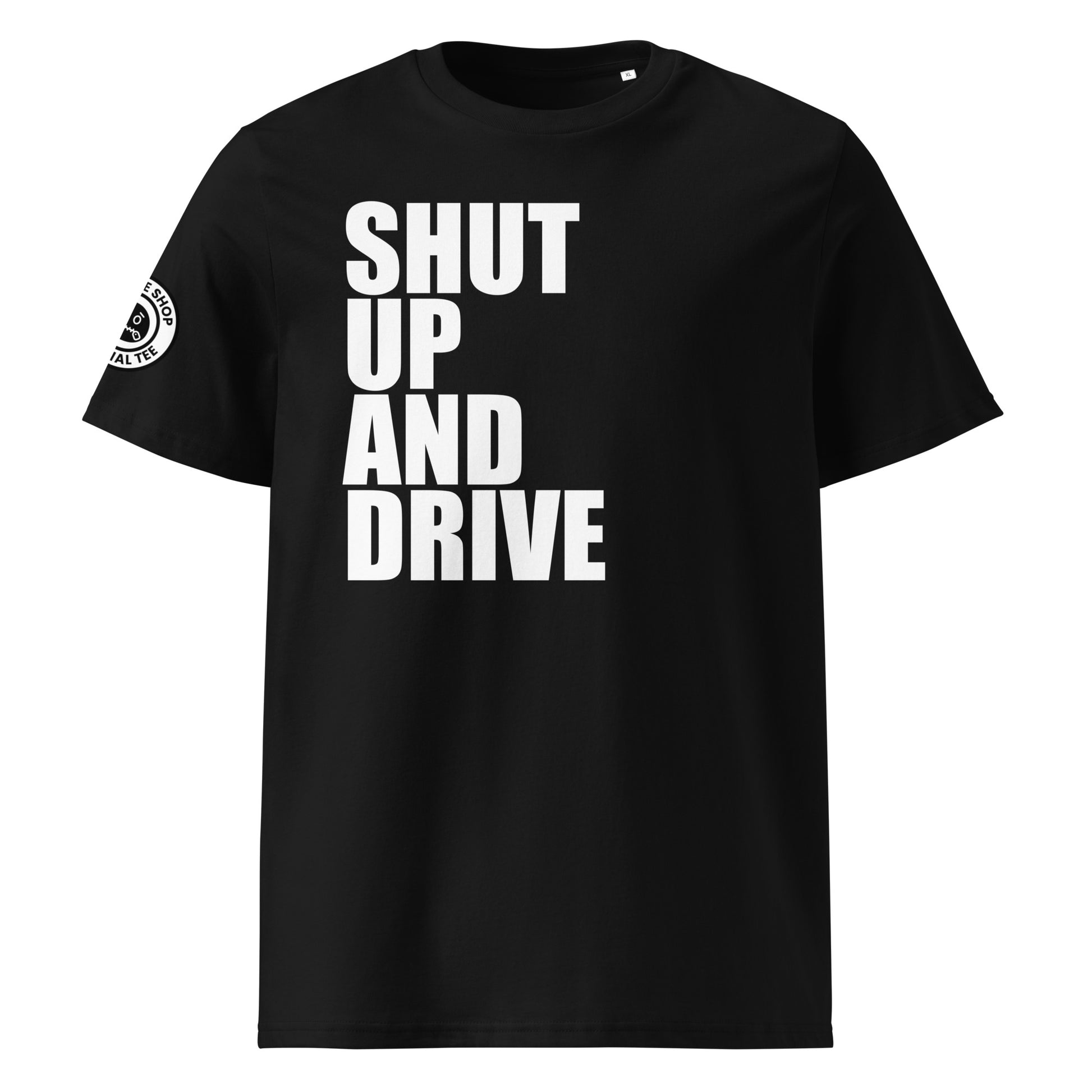 Front view of black unisex t-shirt with bold white “SHUT UP AND DRIVE” slogan in large font across the chest. DTF print, perfect for car meet fans and driving enthusiasts.