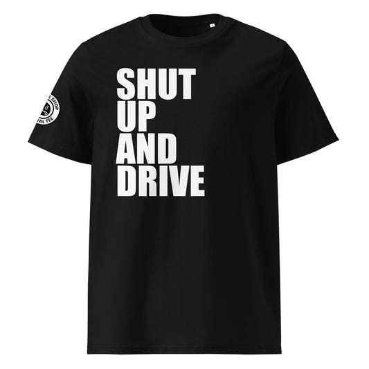 Front view of black unisex t-shirt with bold white “SHUT UP AND DRIVE” slogan in large font across the chest. DTF print, perfect for car meet fans and driving enthusiasts.