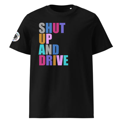 Front view of black unisex t-shirt with “SHUT UP AND DRIVE” slogan in multi-colour harlequin print across the chest. DTF print, perfect for car meet fans and driving enthusiasts.